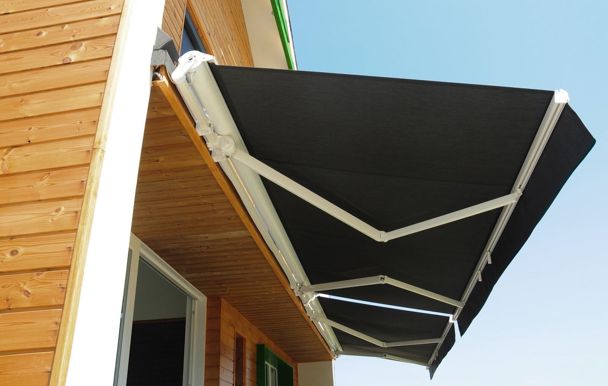 Awning shown open outside of a wooden chalet