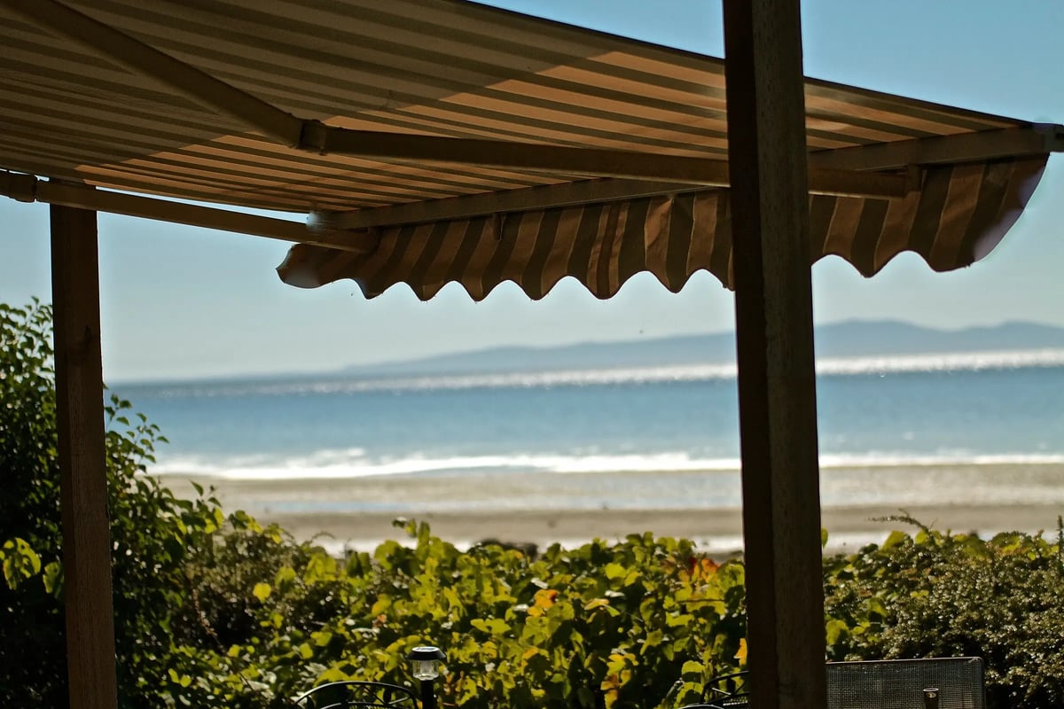 Awning showing a beach and the sea in the distance